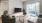 a living room with a tv, a couch and a chair